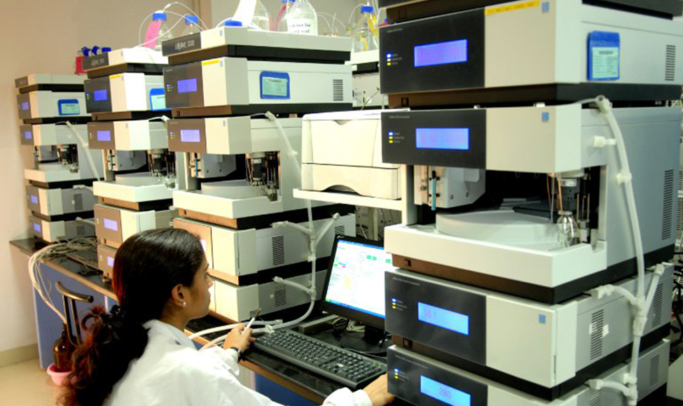 Zydus employee using a HPLC analyzer in a Quality Control laboratory located in the Moraiya plant.